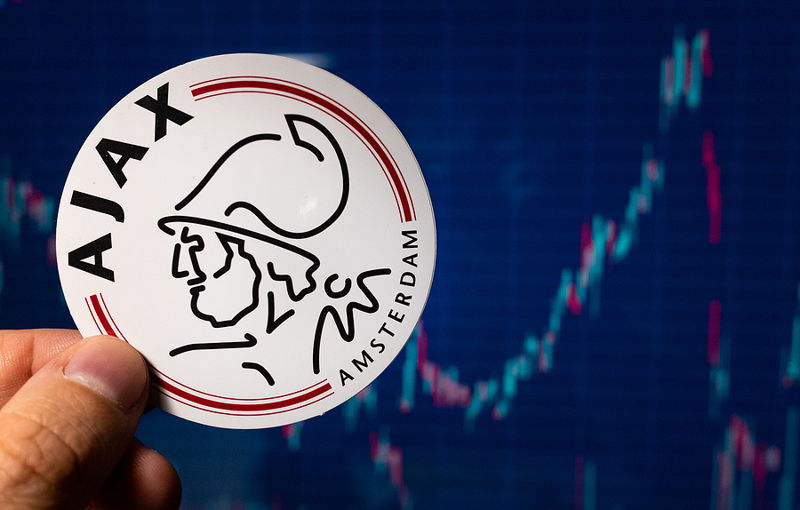 ajax badge with financial charts in the background